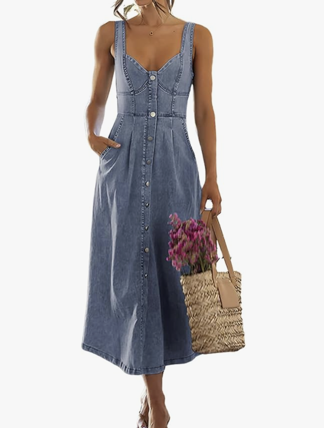 A woman wearing a blue smocked midi denim dress with thin straps, styled for an elevated summer BBQ outfit.