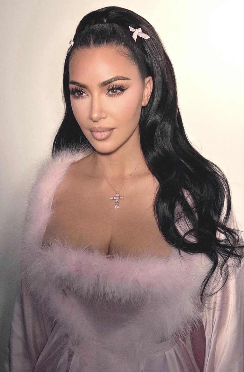 Kim Kardashian wearing a cool-toned lavender faux-fur trimmed top with high-contrast makeup, illustrating how icy and cool-neutral shades harmonize with the True Winter season.