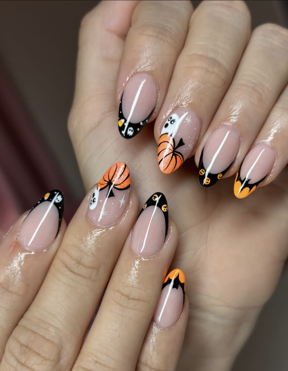 Minimal black pumpkin outlines painted over a milky neutral manicure