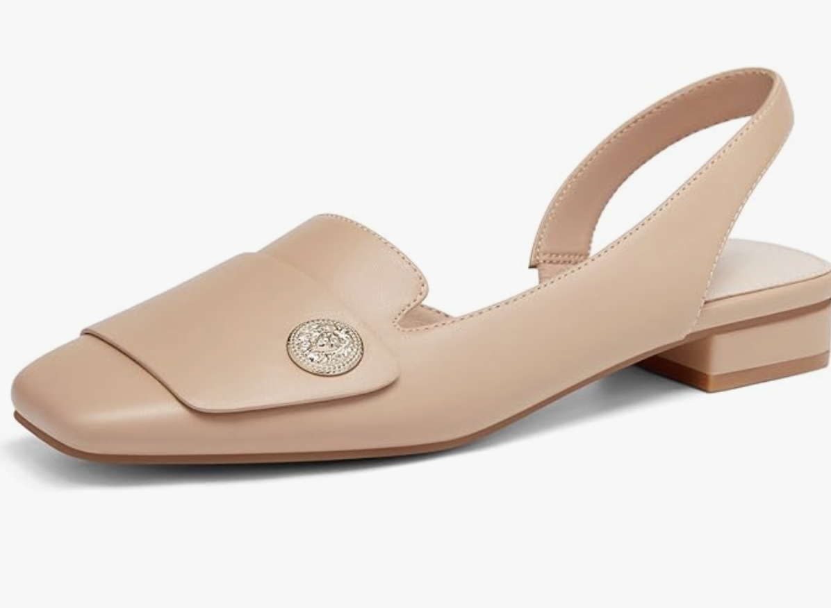 A pair of sophisticated nude leather square-toe flats featuring a decorative gold coin emblem on the vamp, representing the refined minimalism trend for Spring 2026.