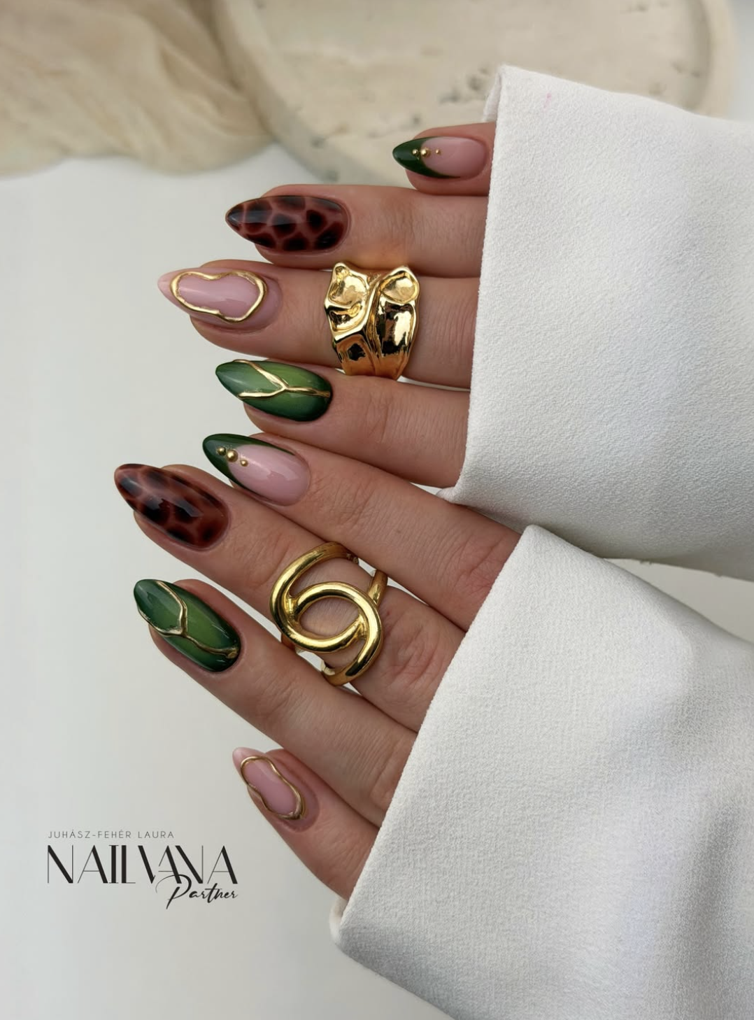 Olive aura manicure with fine gold chrome accents.