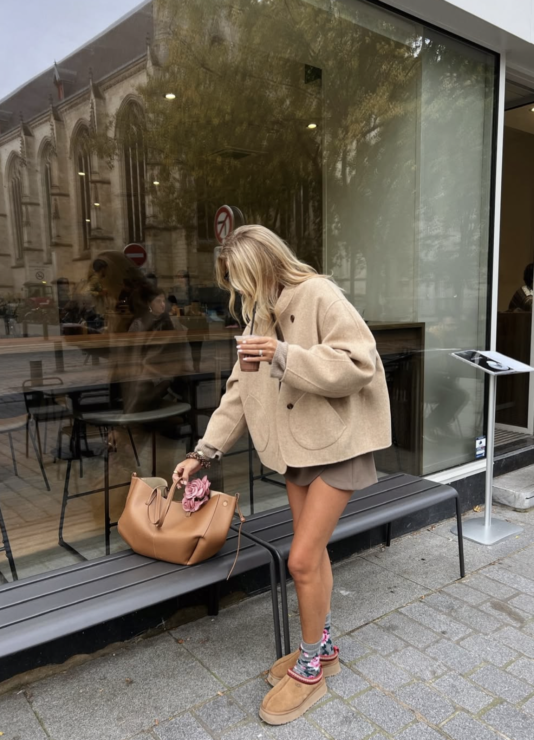 Beige oversized blazer and tonal shorts with patterned socks, chestnut slippers and a tan tote.