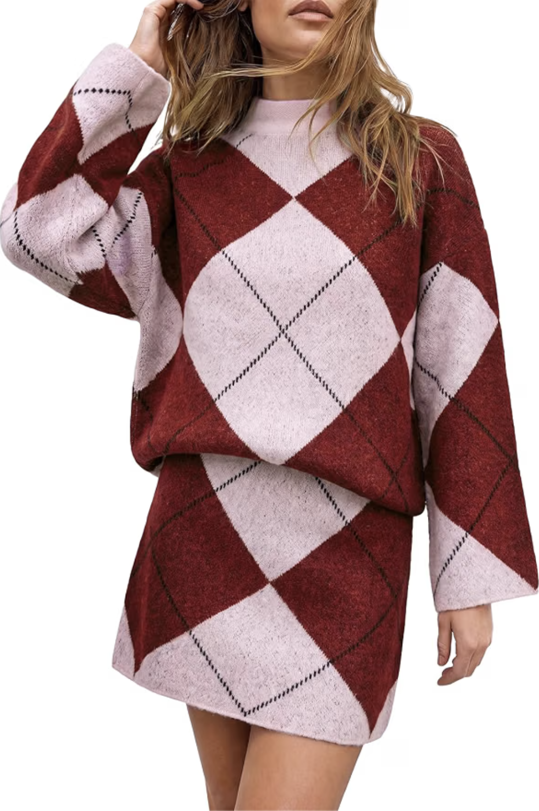 Woman wearing a two-piece burgundy and pink argyle knit sweater and matching mini skirt set