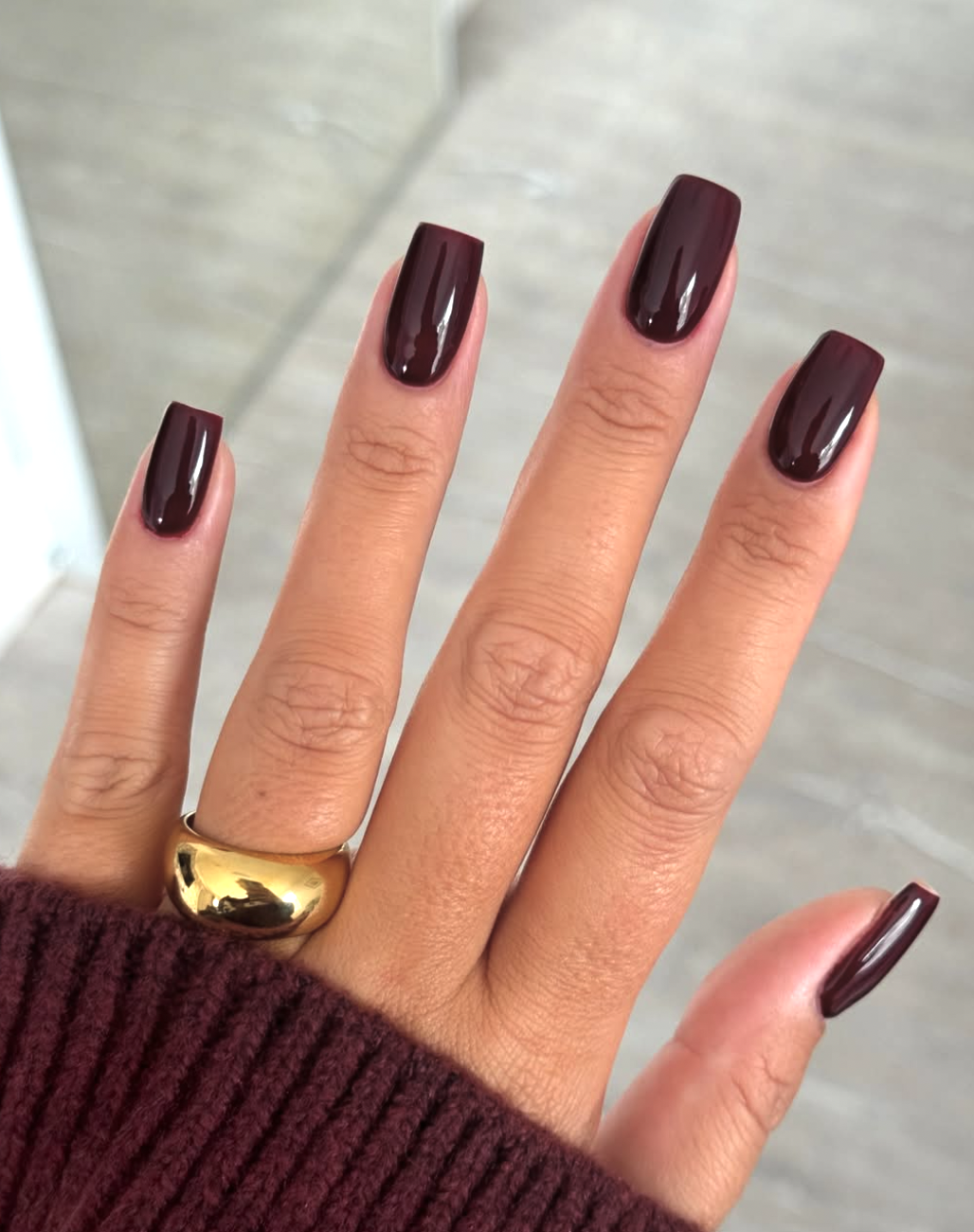 Short squoval fall nails with an ultra-glossy deep-brown finish.