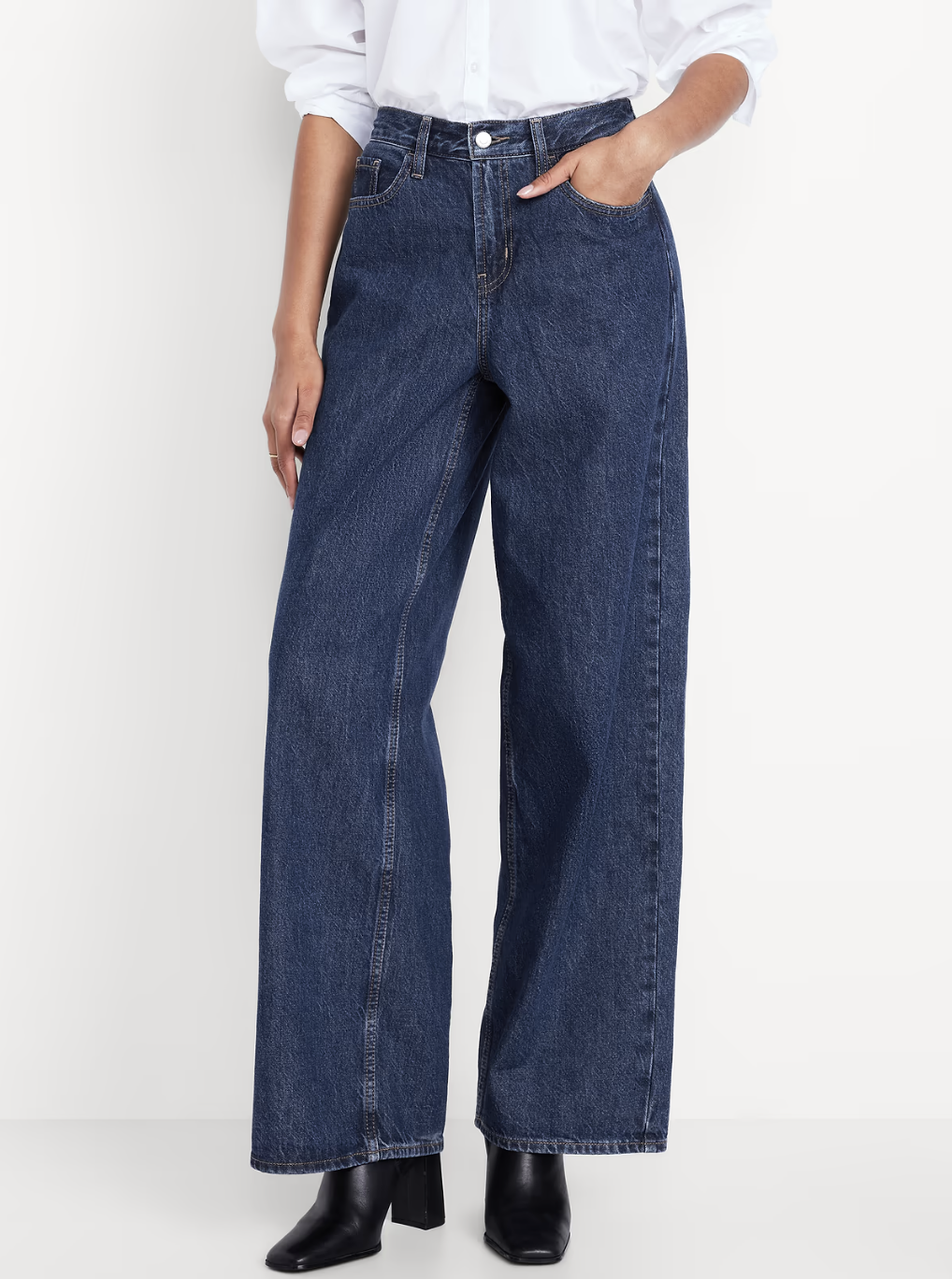 Woman wearing Old Navy Mid-Rise Wow baggy wide-leg jeans with a loose fit through the leg.