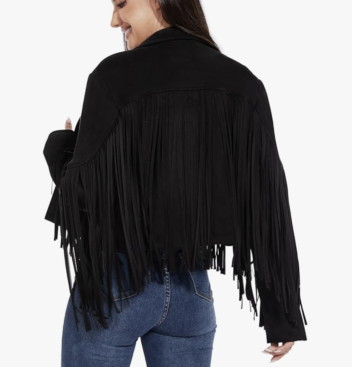 Rear view of a woman wearing a black jacket with long fringe detailing across the back and arms, paired with blue denim jeans.