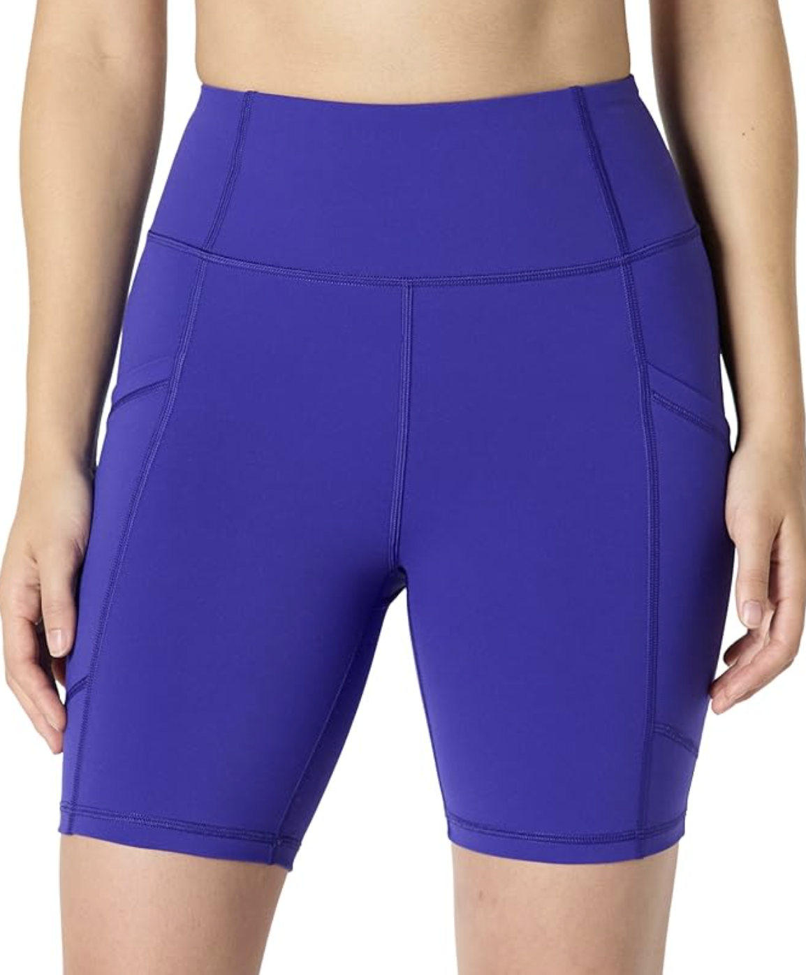 A close-up of a person wearing tight, high-waisted purple athletic gym shorts featuring side slip pockets.