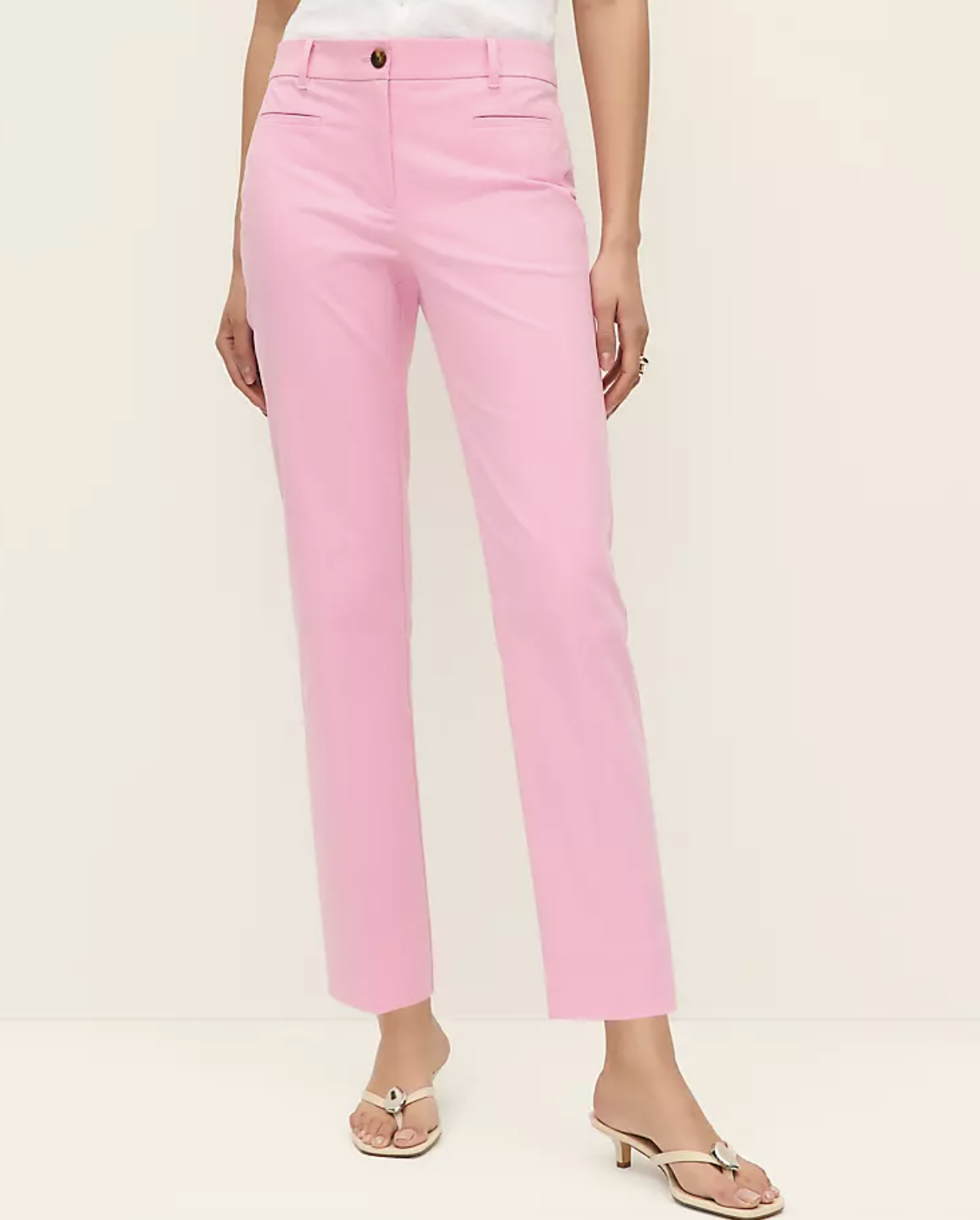A professional stylist's pick for the Ann Taylor Petite Ankle Pant in a bright pink seasonless stretch fabric, styled with neutral kitten heel sandals for a polished spring look.