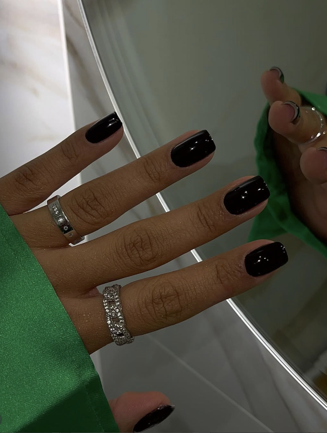 Short squoval nails with a milky base and thin blackberry French tips.