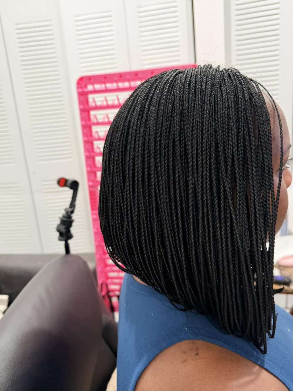 Side-parted asymmetrical braided bob with an angled finish.