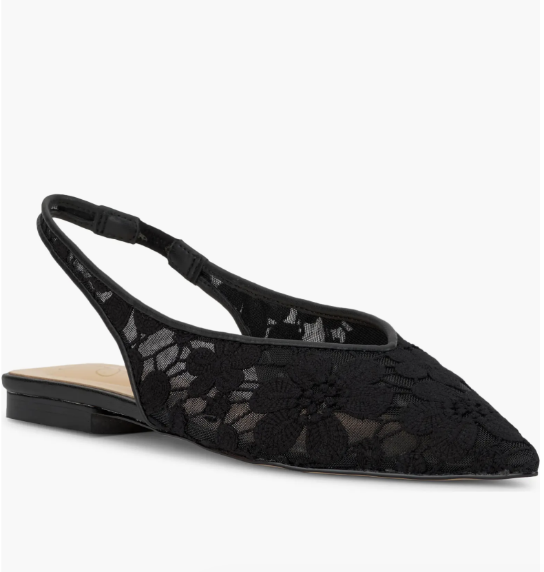Close up of black lace pointed-toe slingback flats with a floral pattern and a slim back strap, styled for an elevated casual look.