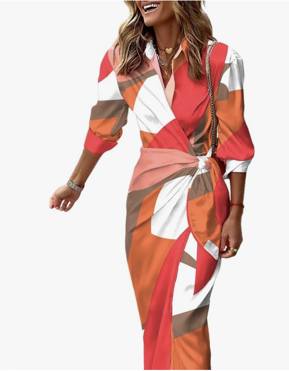 A woman wearing a long-sleeve floral wrap midi dress with an orange and brown geometric pattern, styled with a gold heart pendant necklace for a bright spring outfit.