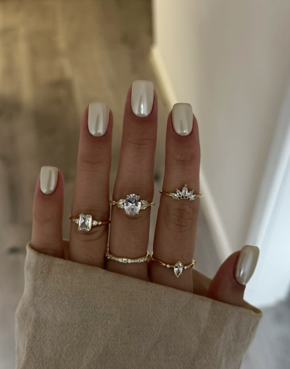 Long square-shaped nails with a high-shine vanilla chrome finish that catches the light with an iridescent pearly glow, showcasing cute June nail ideas.
