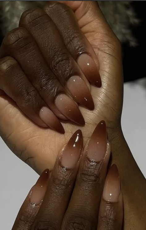 Glossy nails with a blended gradient from creamy beige to warm caramel brown.