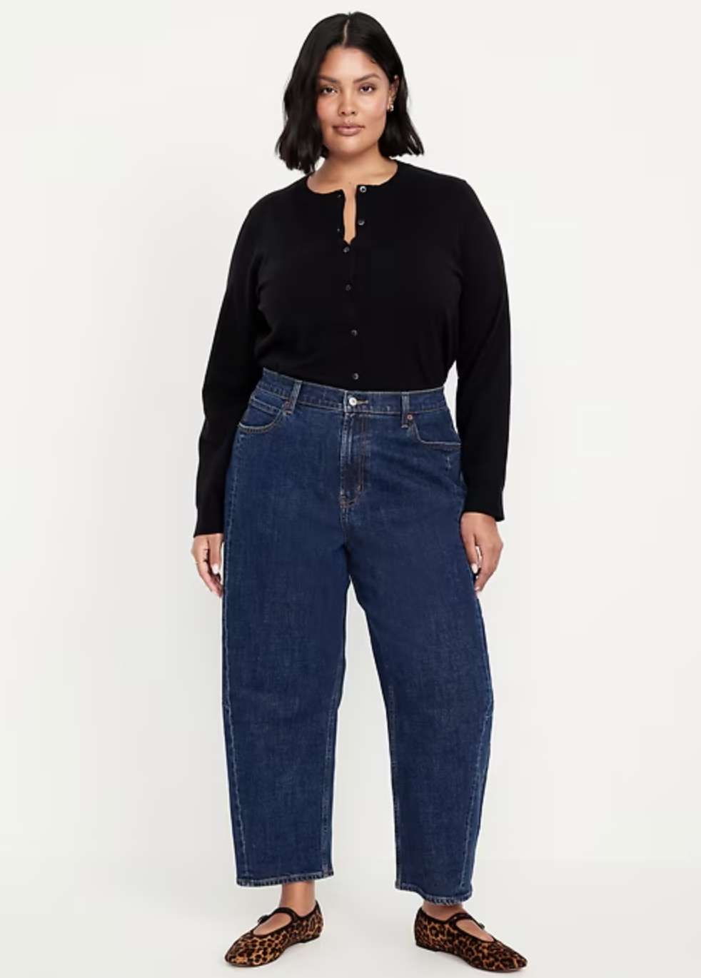 A woman styling the Old Navy High-Waisted Barrel Ankle Jeans in a dark wash, showing the tapered petite fit that elongates the leg.