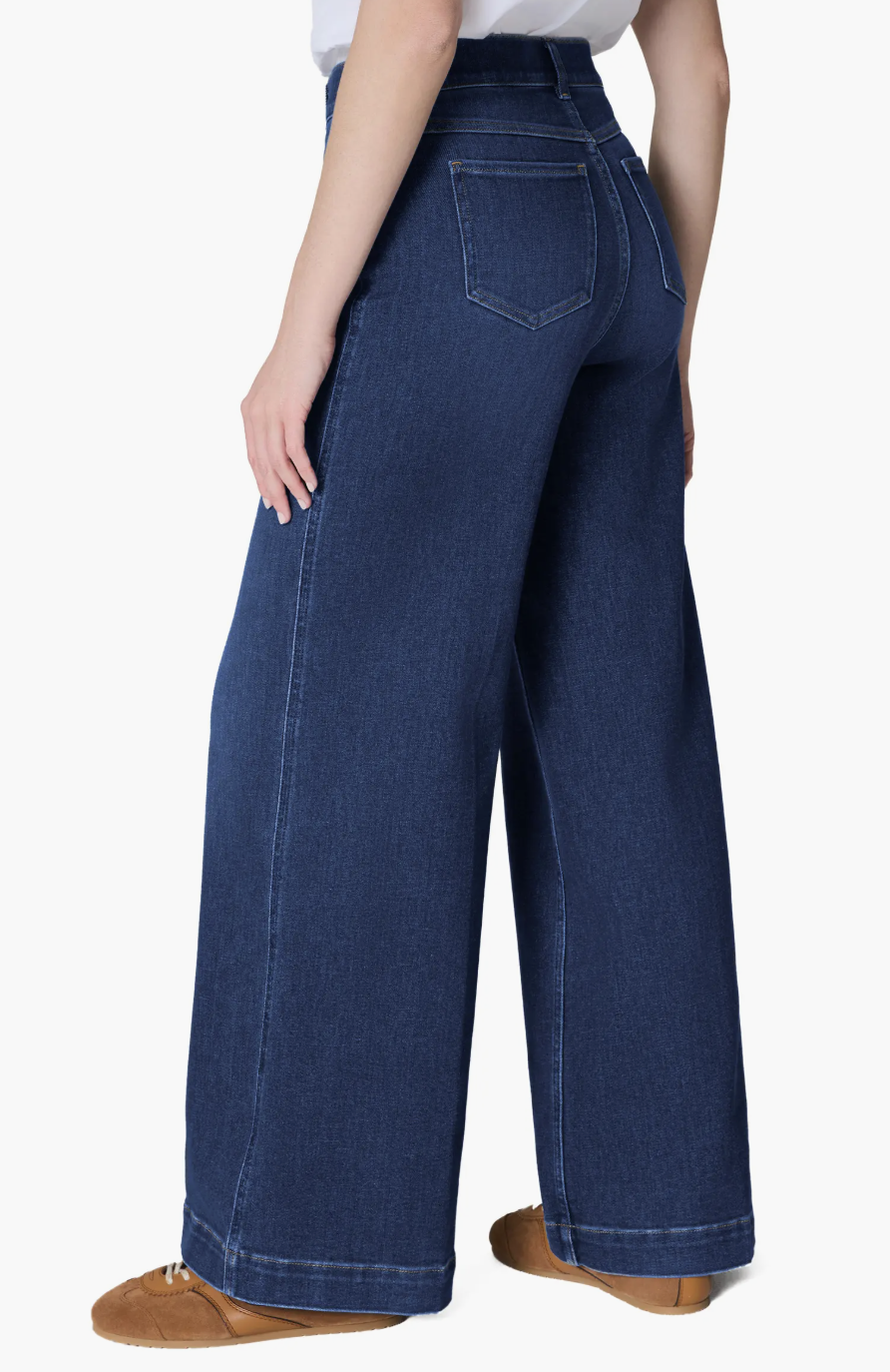 "A pair of dark wash Spanx EveryWear Pull-On Wide Leg Jeans styled with brown leather boots. These high-waisted shaping jeans feature a smooth front and a trendy wide-leg silhouette."