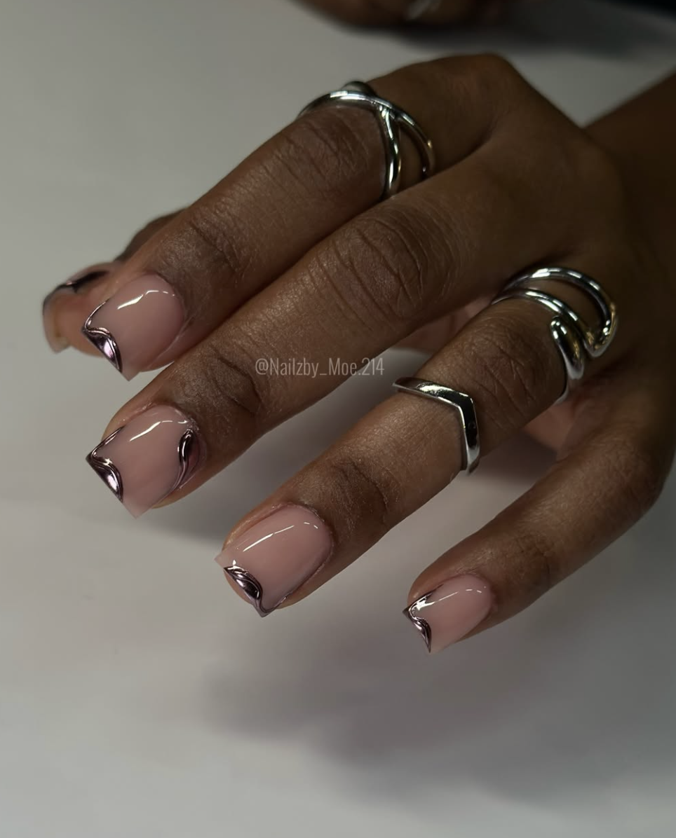 Short nails with a subtle pewter chrome glow over a sheer neutral base.