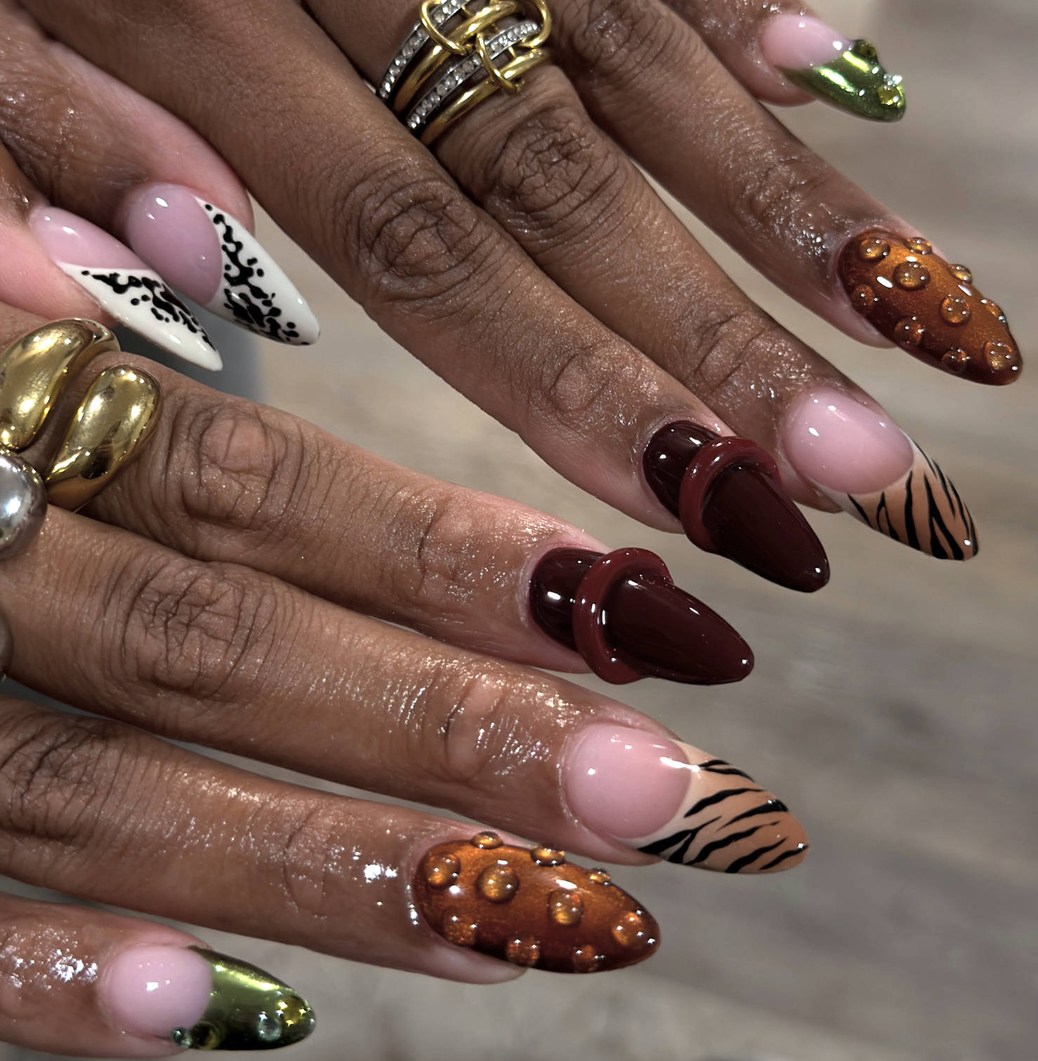 Burnt orange Thanksgiving nails with delicate gold foil accents