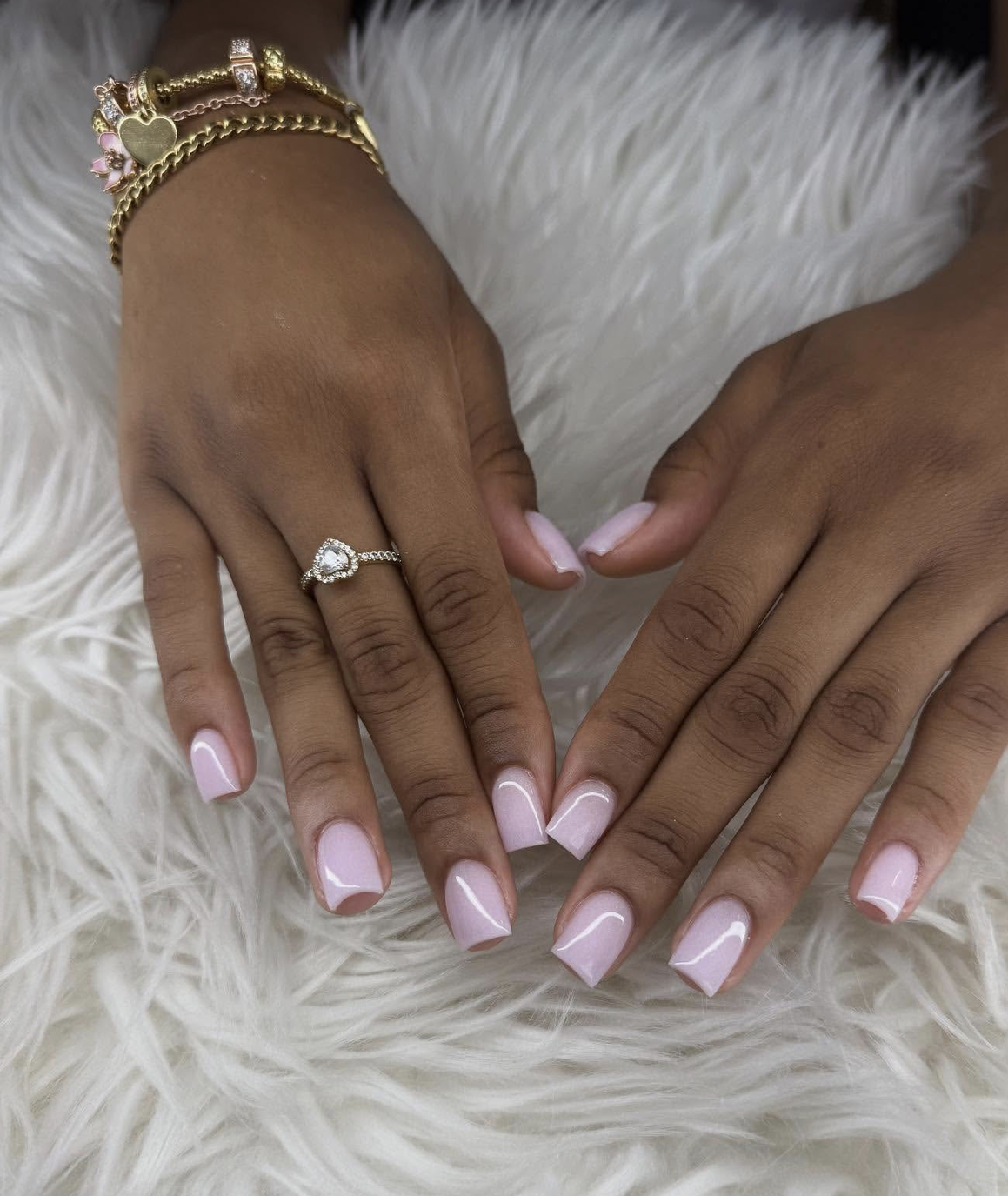 Short square-shaped gel nails in a soft, opaque cotton candy pink finish.