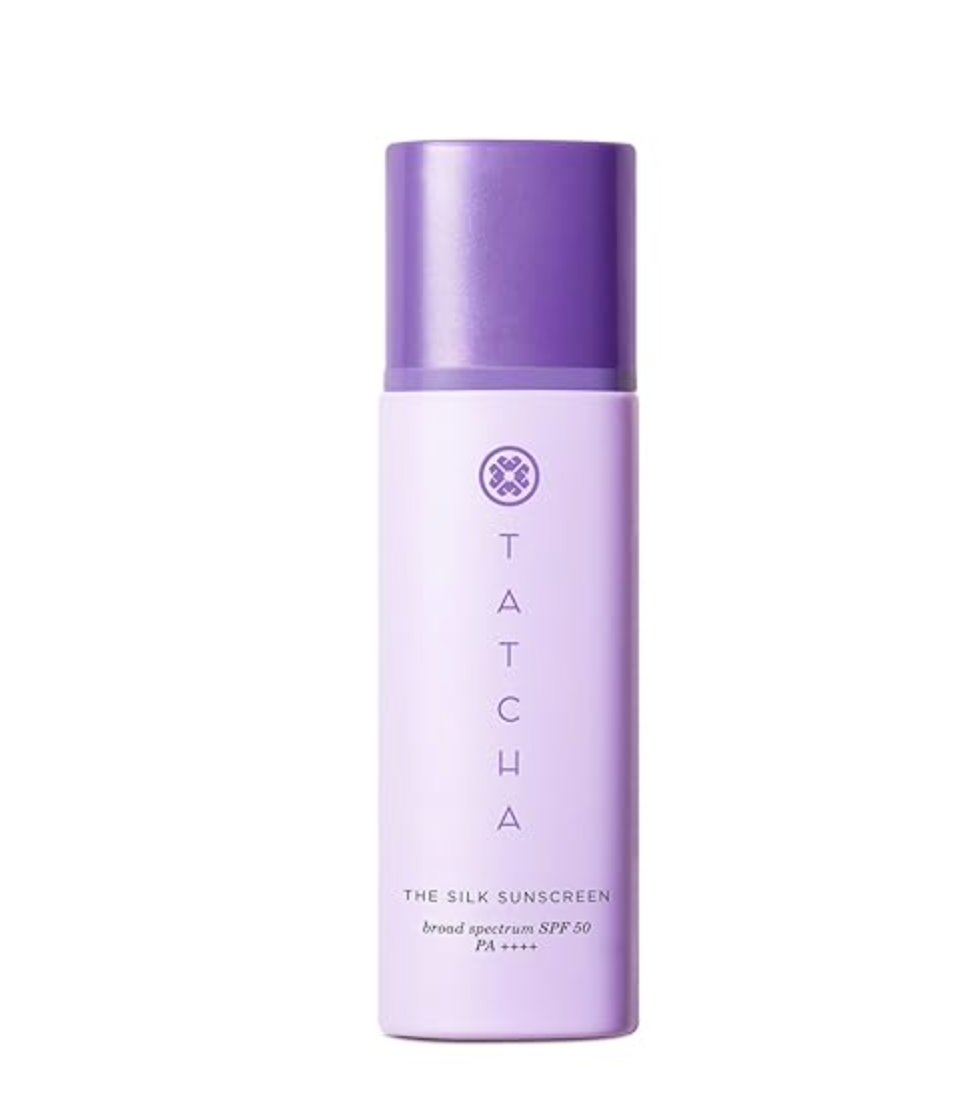 Product shot of Tatcha The Silk Sunscreen Broad Spectrum SPF 50 in a sleek lavender bottle, featured as a luxury mineral sunscreen that leaves a silky, makeup-ready finish.