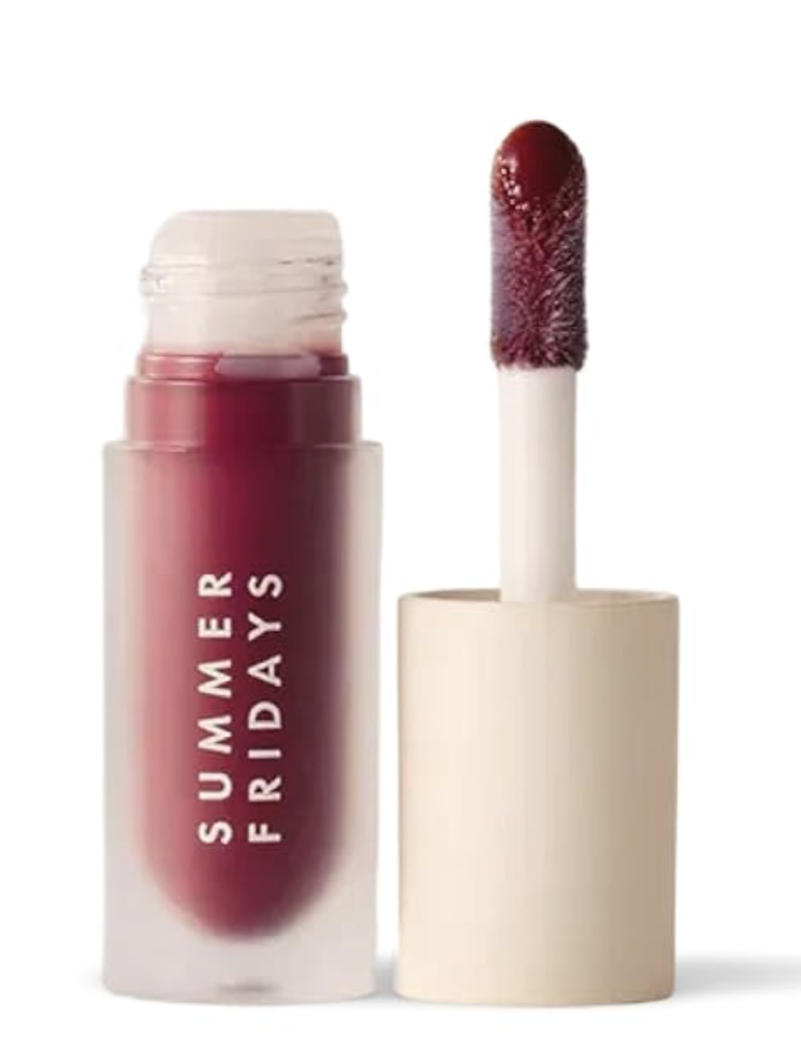 A bottle of Summer Fridays Dream Lip Oil in the shade Pink Cloud, featuring a frosted glass container with a beige cap and a large doe-foot applicator showing the sheer pink tint.