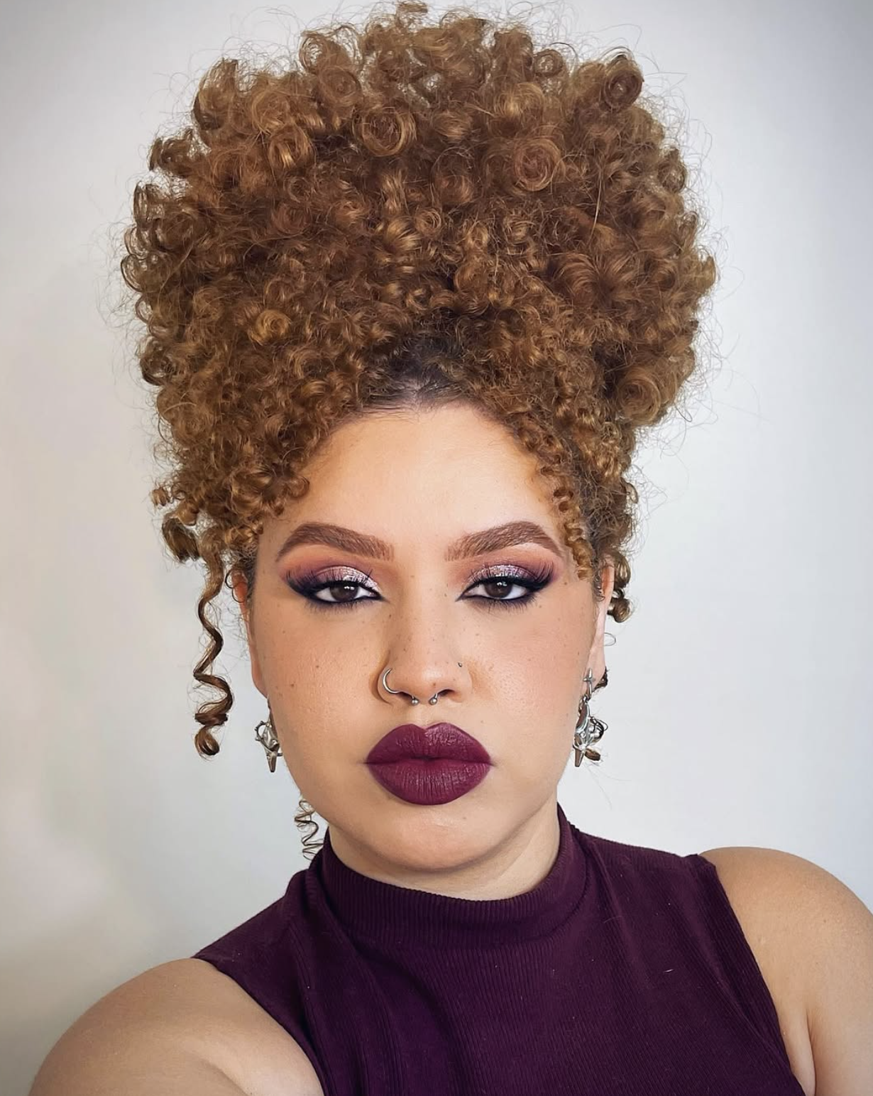 Close-up of deep burgundy lipstick paired with minimal eye makeup