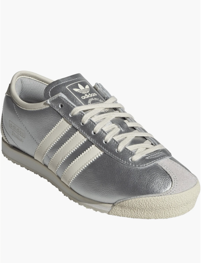 Metallic silver adidas x C.P. Company Italia 70s sneaker featuring white triple stripes, white laces, and a vintage-style gum rubber outsole.