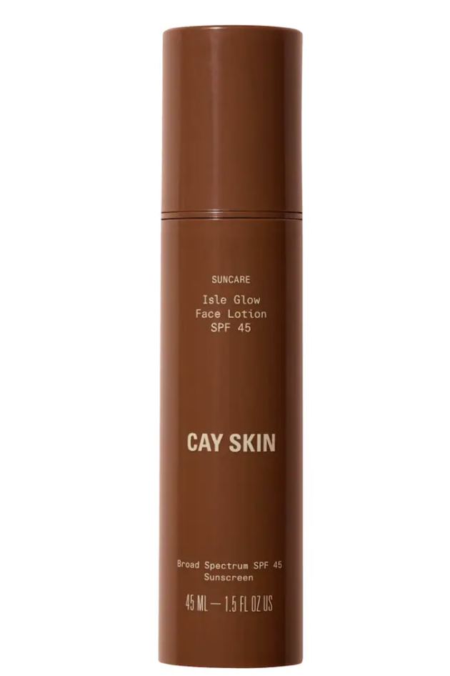 Cay Skin Isle Glow Face Sunscreen Moisturizer SPF 45 bottle by Winnie Harlow, featuring sea moss and niacinamide for a dewy, non-ashy finish on deep skin tones."
