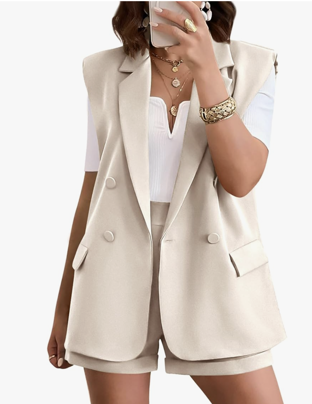 A woman wearing a beige sleeveless tailored blazer and matching high-waist shorts, styled as a sophisticated and modern dinner outfit for a cruise.