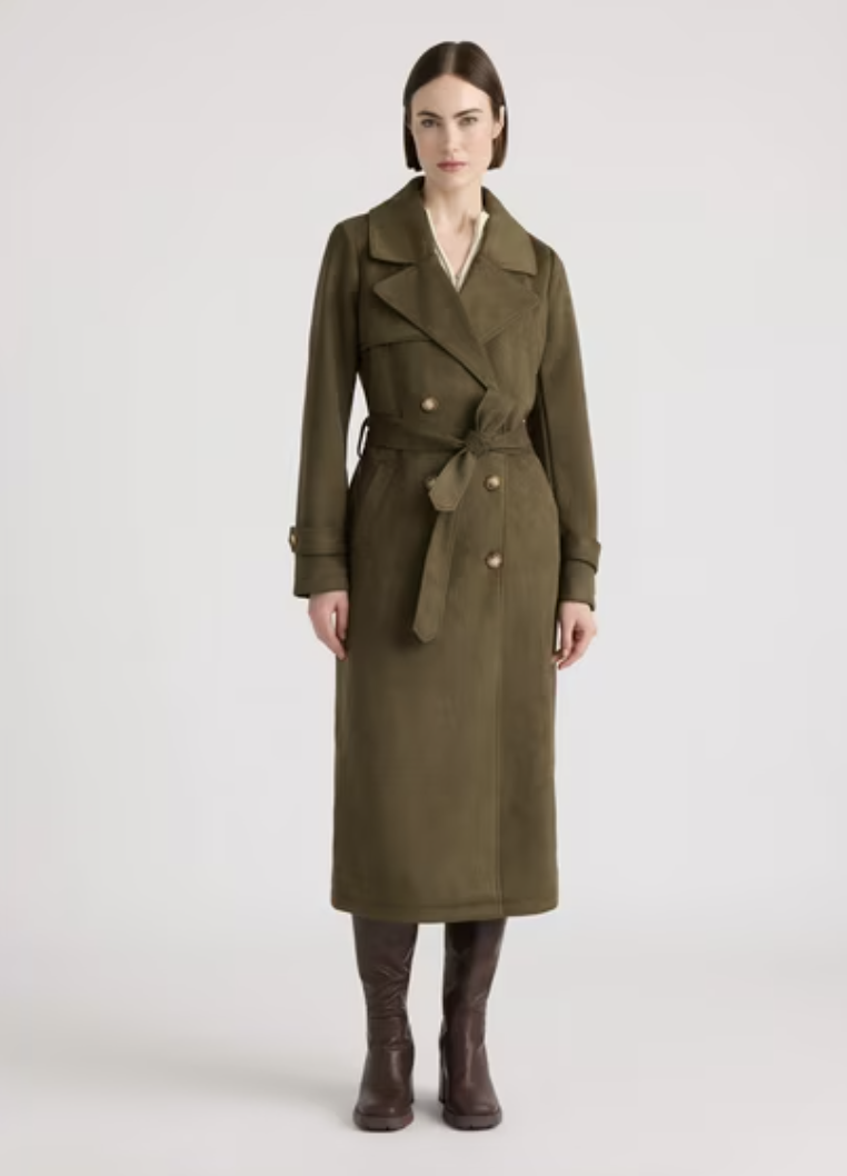 Woman wearing a long olive belted trench coat with dark brown knee-high boots.