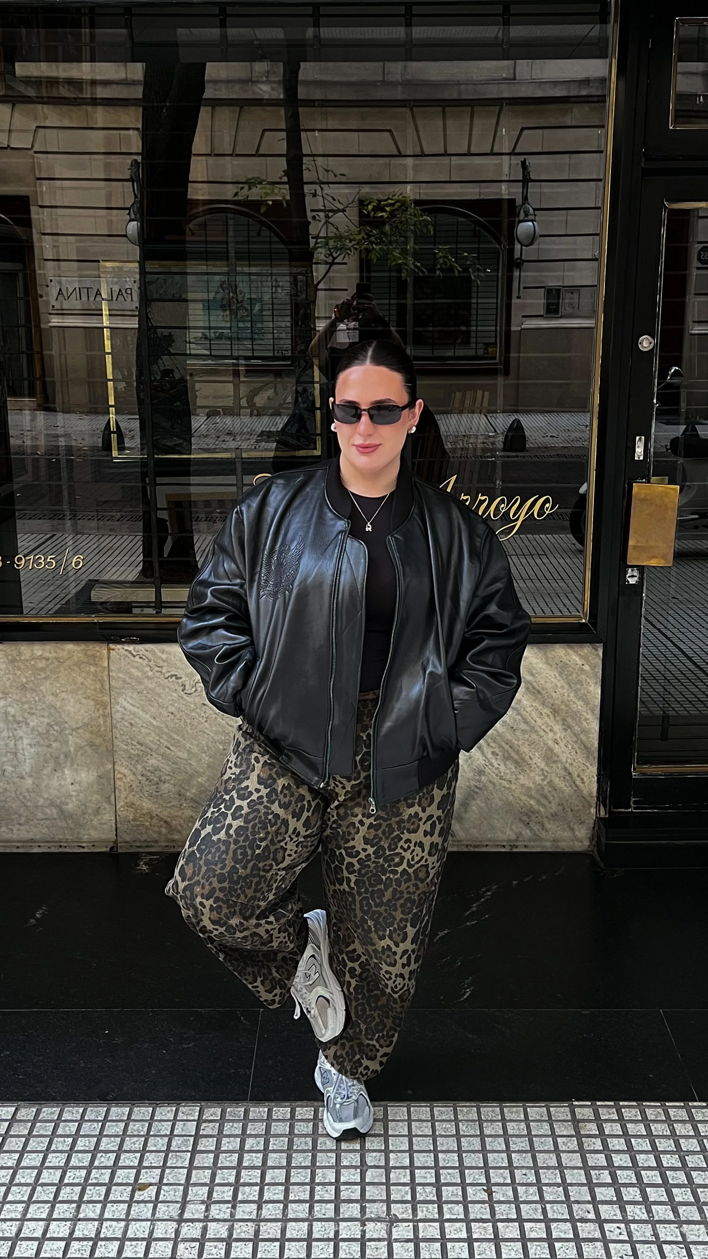 Chicago fashion stylist wearing leopard print wide-leg curvy jeans and sneakers to demonstrate a gap-free waistband fit.