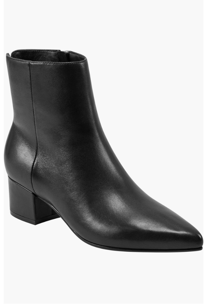 A close-up of a sleek black leather ankle boot with a sharp pointed toe and a sturdy block heel.