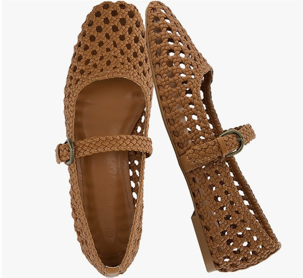 A close-up of a pair of brown woven leather Mary Jane flats with a slender ankle strap and buckle detail.