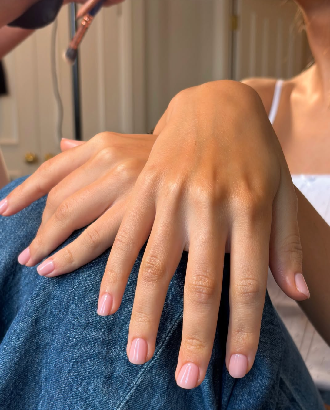 Long almond shaped nails with a sheer, jelly-like rosy pink polish and a high-gloss soap nail finish.