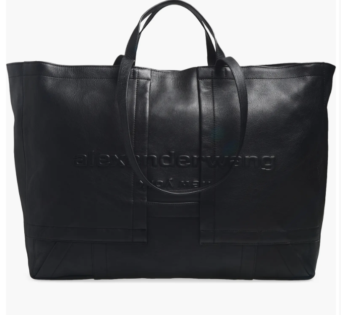 An oversized black leather tote bag with a slouchy, relaxed silhouette and thin shoulder straps.