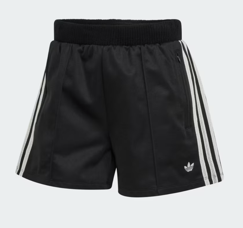 A close-up of classic black Adidas athletic track shorts featuring the signature white three-stripe detailing down the sides and a small white embroidered trefoil logo.