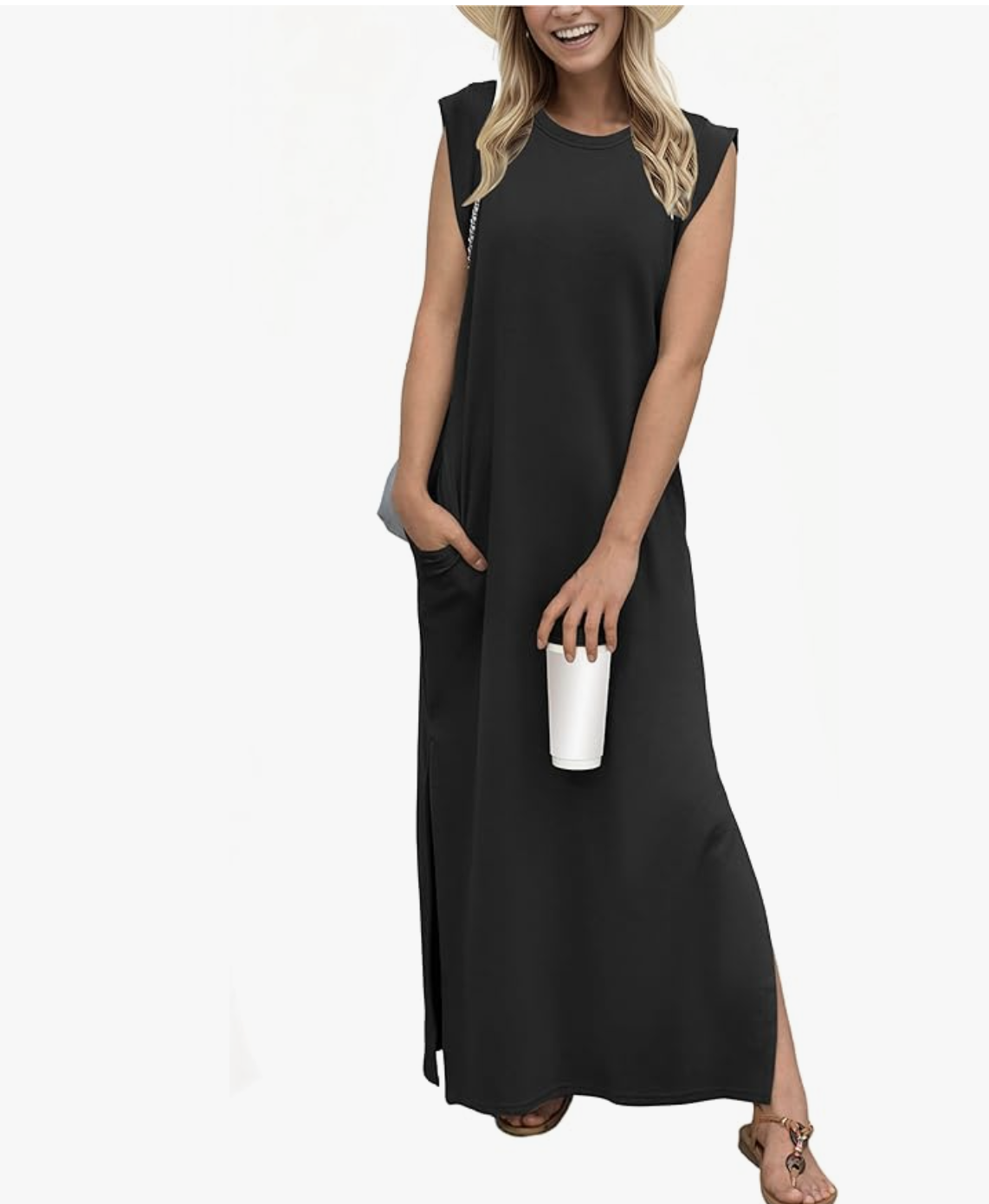 Close-up of a smiling woman wearing a sleeveless black cotton maxi dress with an oversized, relaxed muscle-tee shoulder design, styled with a wide-brim straw hat.