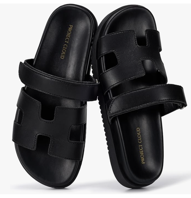 A pair of black Project Cloud genuine leather slide sandals with a double-strap design and a comfortable plush insole.