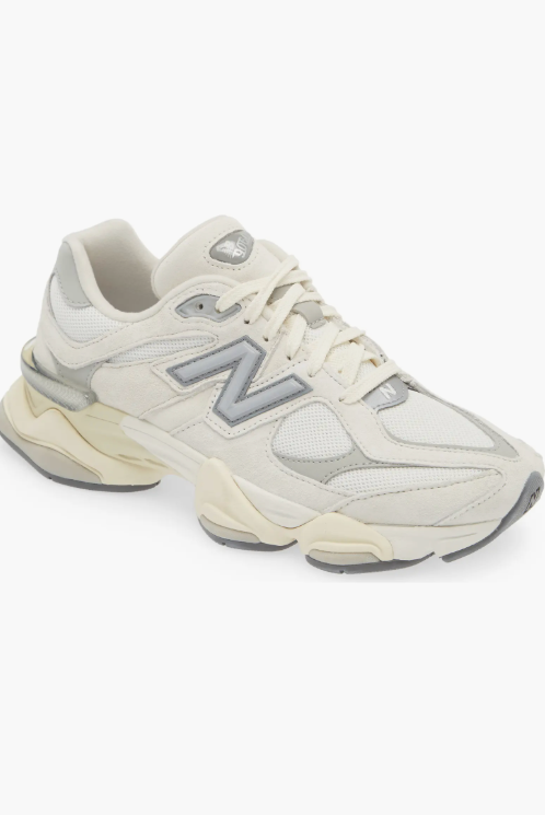 Product shot of New Balance 9060 chunky sneakers in cream and grey, featured as a comfortable and modern footwear choice for styling baggy jeans.