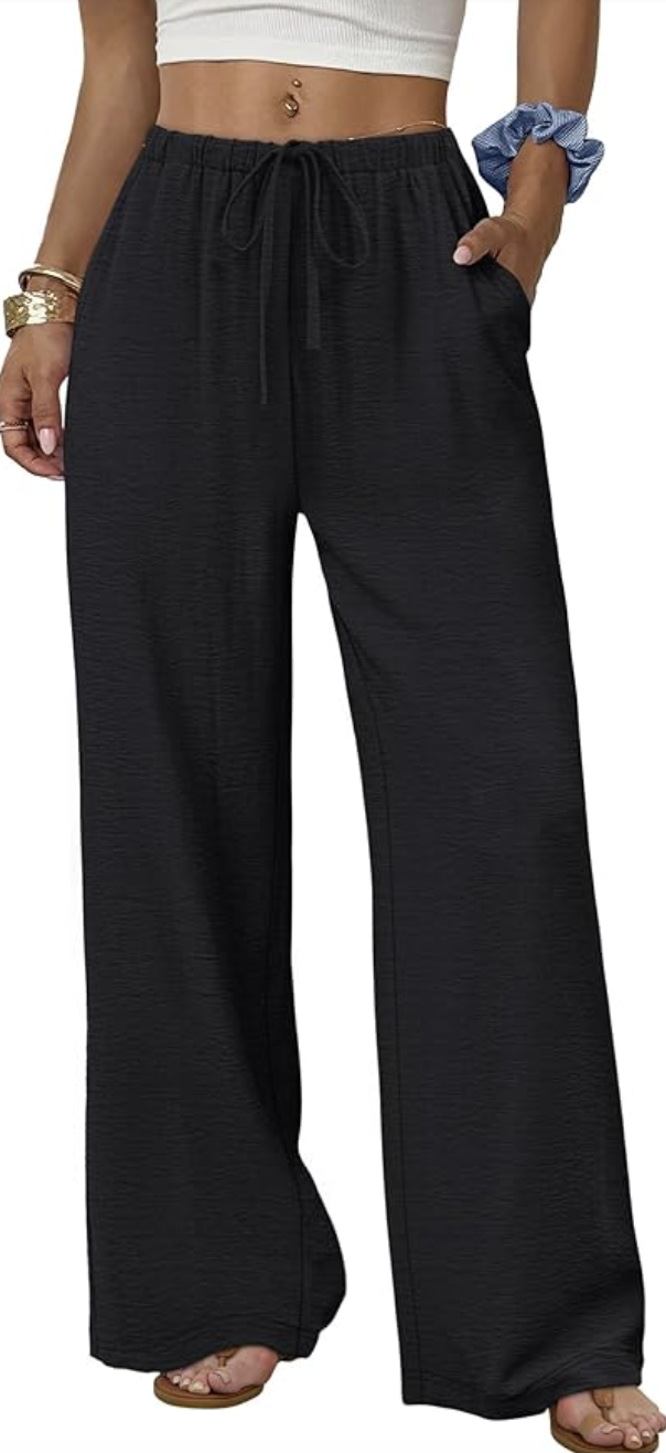 White v-neck tank top tucked into white linen pants with a brown belt — a simple and polished summer outfit for moms
