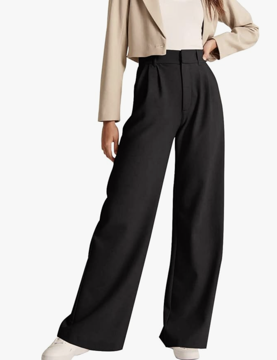 A pair of pro stylist-recommended high-waisted black work pants styled with white sneakers, serving as a versatile base for the "Dress Over Pants" layering formula.