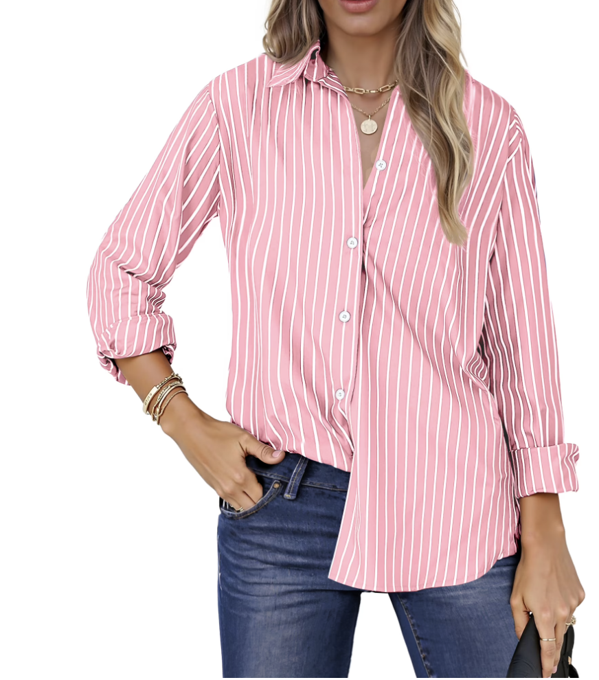 A person wearing an oversized pink and white vertical striped button-down shirt tucked into blue jeans, featuring rolled-up sleeves and gold bracelets.