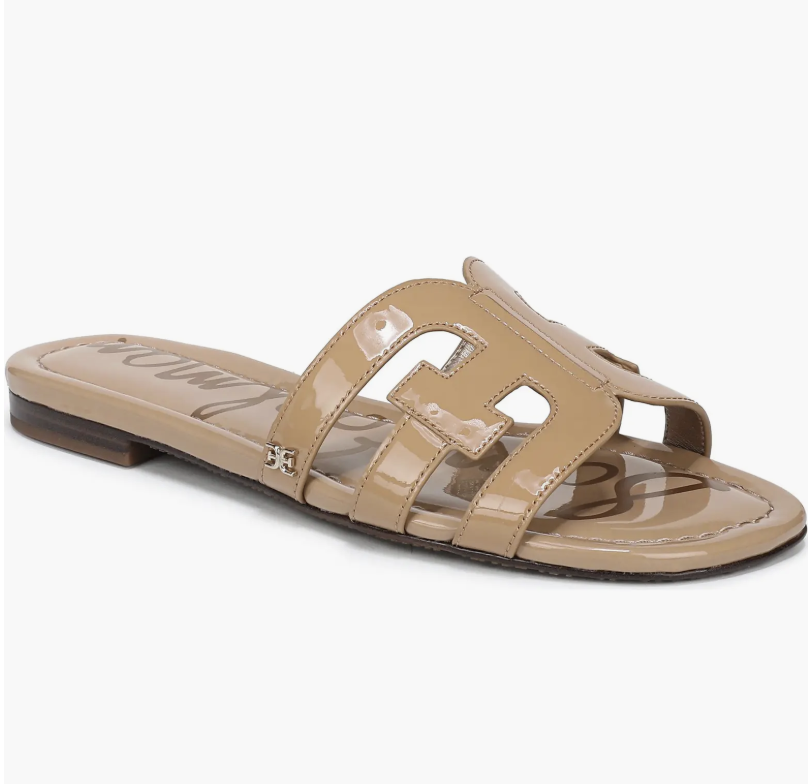 A pair of tan Sam Edelman Bay cutout leather slide sandals with a minimalist flat sole, shown as a product recommendation for maxi dresses.