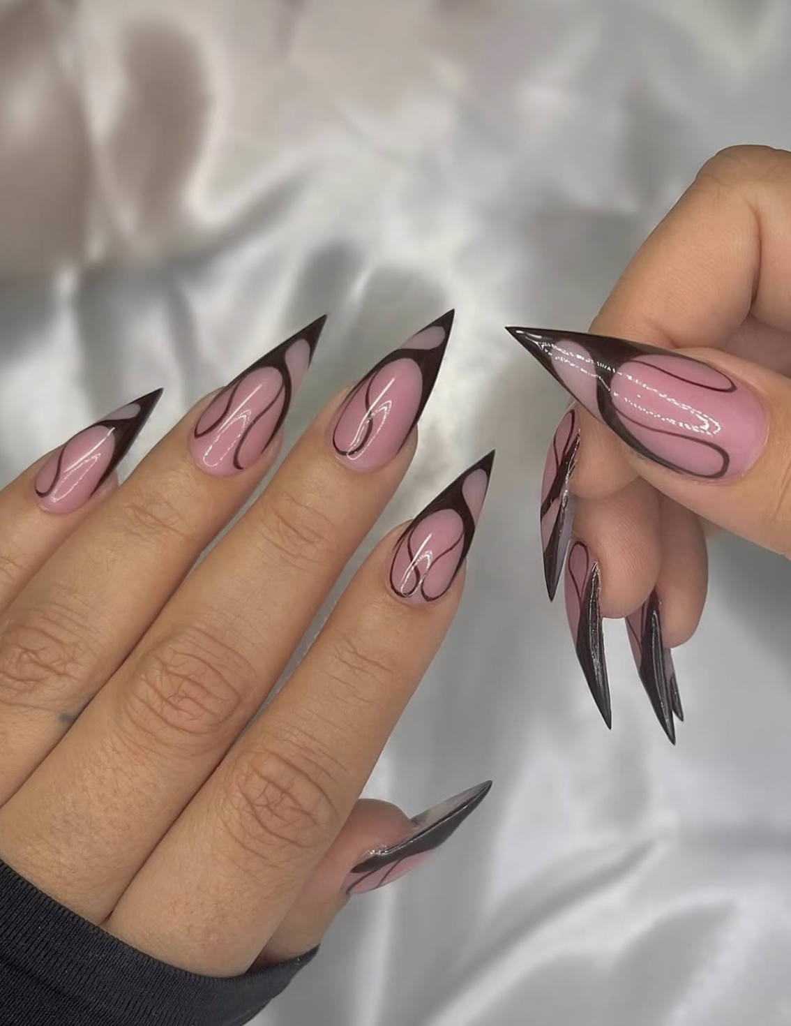 caramel nude and chocolate accent nails manicure photographed close up on hands.