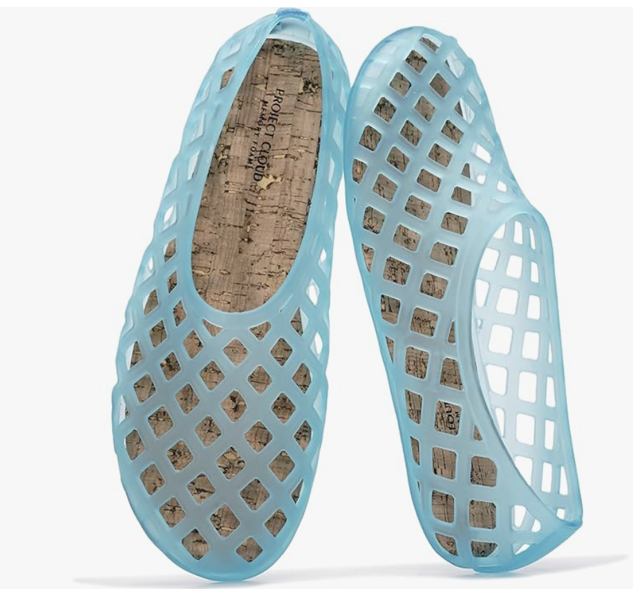 A close-up view of a pair of modern light blue jelly flats featuring a woven cage design and a comfortable cork-textured cushioned insole.