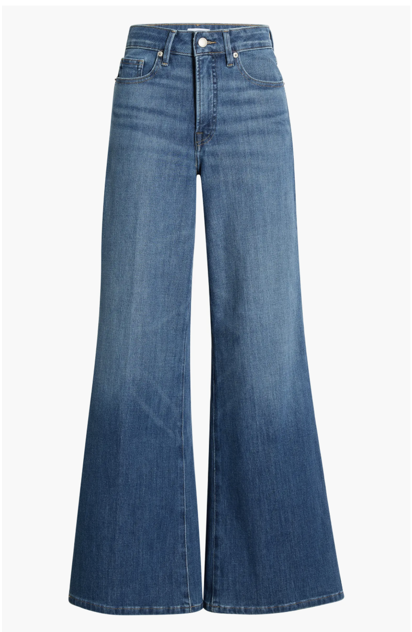 A pair of Good American Soft-Tech Good Waist Palazzo Jeans in a medium blue wash, featuring a high-rise contoured waistband and a dramatic wide-leg flare.