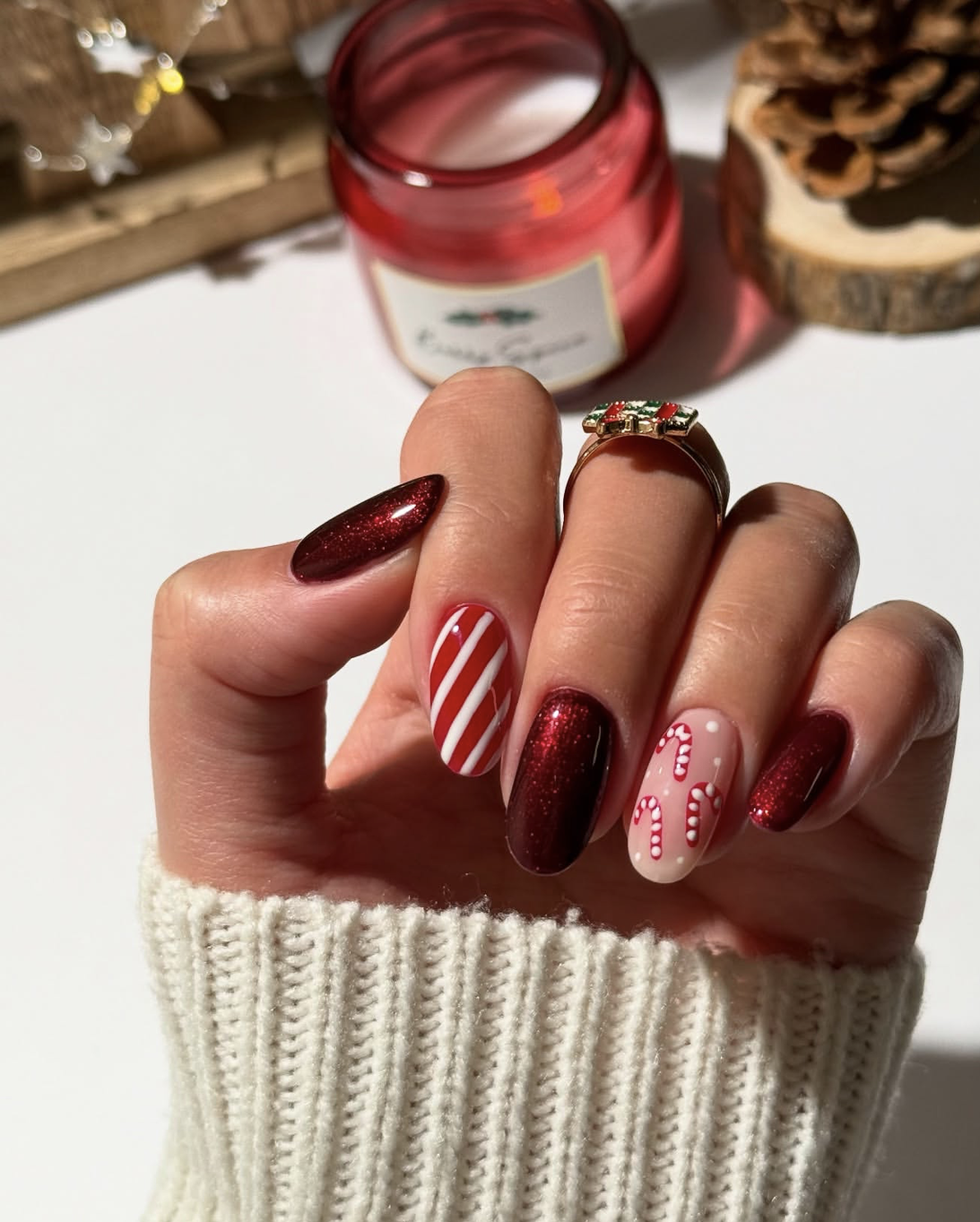 Classic red and white striped candy cane nail design for Christmas