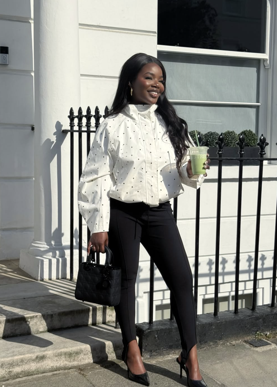 woman wearing a white polka dot blouse with black trousers — one polka dot statement piece styled simply