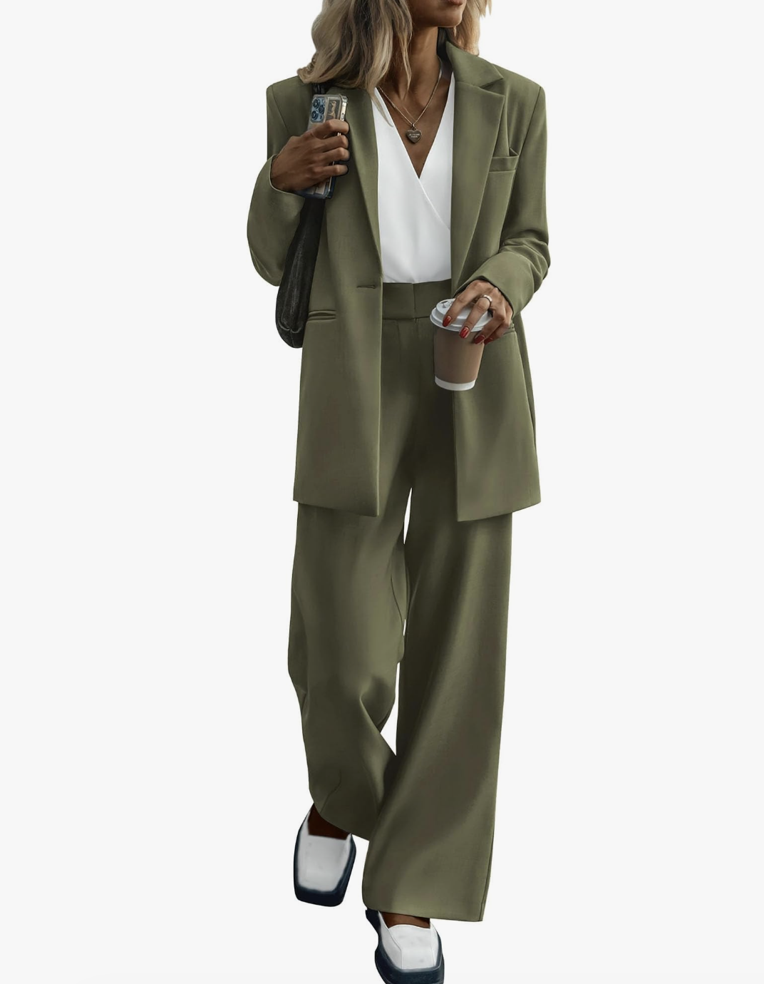 A woman wearing a coordinated olive green oversized blazer and wide-leg trousers set with white sneakers, a perfect example of smart casual work outfits.