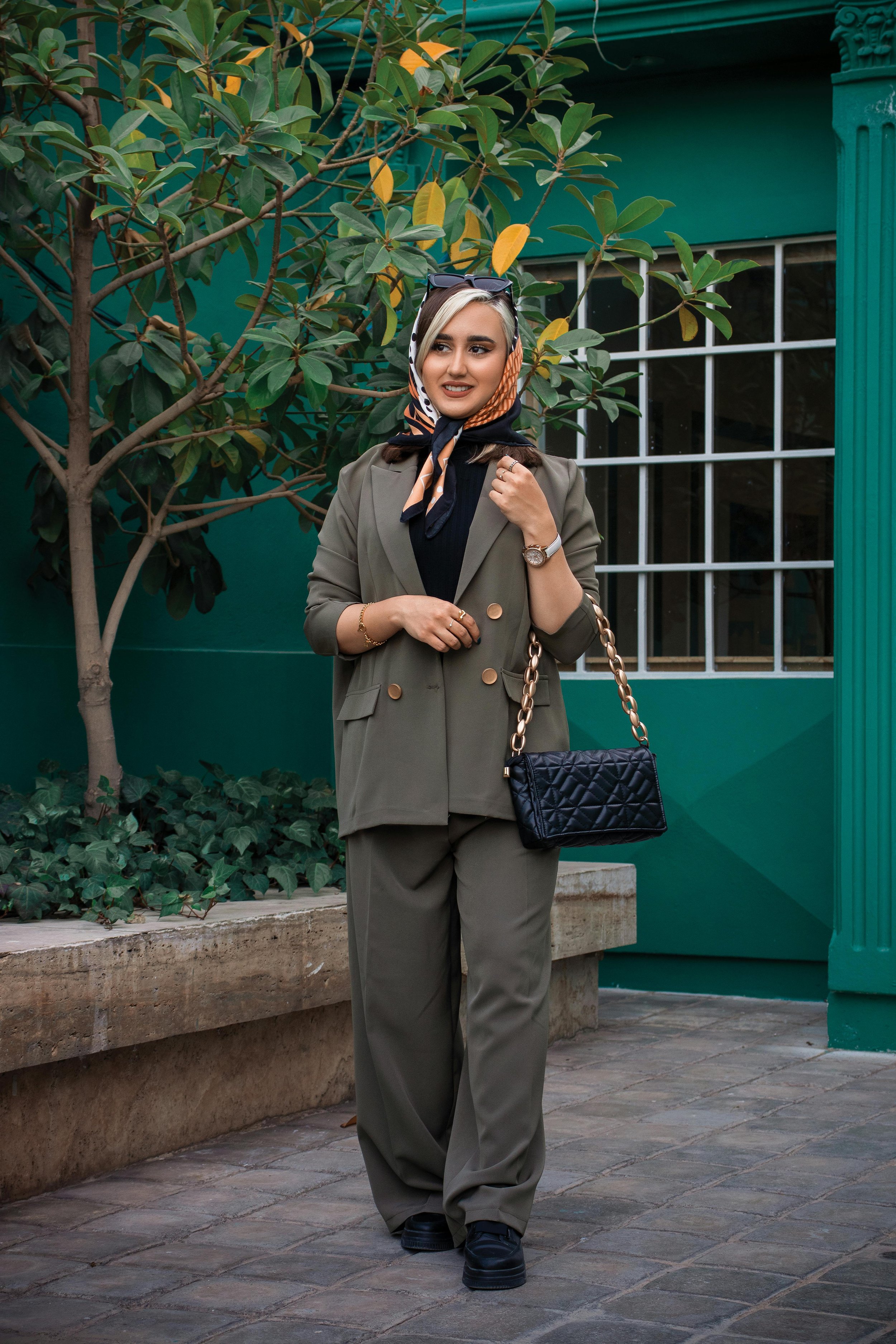 Woman with Headscarf in Suit Posing on Sidewalk
